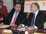 Pedro Solbes (d) conversa con el presidente del Banco Popular, Ángel Ron, durante la firma de renovación de la línea ICO-PYME 2009. (EFE)