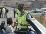 Un agente de la Guardia Civil realiza un test de alcholemia a un conductor.
