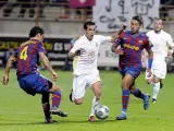 El jugador de la Cultural Leonesa, Ferrán (c), avanza con el balón entre los defensas del FC Barcelona, Márquez (i) y Jeffren Suárez.