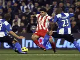 El delantero argentino del Atlético de Madrid Agüero (c) controla el balón ante los jugadores del Hércules, el defensa francés Noé Elias Pamarot (d) y el centrocampista argentino Matias Lionel Fritzler.