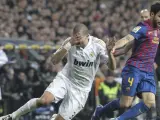 El defensa portugués del Real Madrid Pepe (i) cae ante Cesc Fábregas, del FC Barcelona.