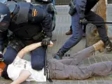 Un policía custodia a un detenido durante los incidentes entre estudiantes y policías en el centro de Valencia.