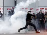 Manifestantes atacan a los mossos en Barcelona durante los disturbios ocurridos en la jornada de huelga general convocada por los sindicatos.