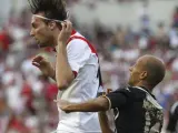 El centrocampista del Rayo Vallecano Miguel Pérez "Michu" (i) lucha por un balón con el jugador del Granada Manuel Lucena.