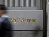 Un hombre pasa delante de un letrero de Wall Street en la Bolsa de Nueva York, Estados Unidos.