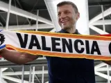 El entrenador serbio Miroslav Djukic posa con una bufanda del Valencia CF a su llegada a Valencia para cerrar los últimos detalles de su fichaje por la entidad de Mestalla.