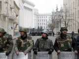 Protestantes antigubernamentales protegen el edificio del Parlamento ucraniano en Kiev, tras la salida del presidente Yanukovich a la ciudad oriental de Járkiv.