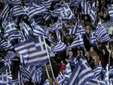 Simpatizantes del partido conservador Nueva Democracia ondean banderas griegas en un encuentro celebrado en la jornada de reflexión en Grecia.