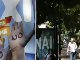 Varios viandantes esperan el autobús junto a una marquesina en Atenas que pide el 'sí' (nai) en el referéndum griego, mientras que un cartel próximo solicita el 'no' (oxi).