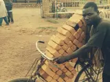 Un hombre burundés transporte ladrillos en su bicicleta