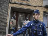Policías belgas vigila el exterior de una vivienda en el número 64 de la calle Busselenberg, en el distrito de Anderlecht-Bruselas, durante una redada tras los atentados en Bruselas.