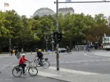 Varias personas cruzan la calle (en bicicleta y a pie) en Berl&iacute;n.