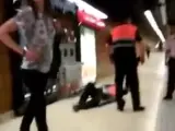 Un miembro de seguridad del metro de Barcelona tumbado en el suelo tras ser agredido por dos jóvenes.