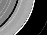 Imagen del anillo F de Saturno interrumpido por el impacto de un meteorito con la luna Pandora al fondo.