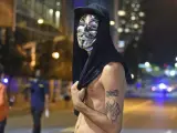 Una manifestante protesta, con una careta de V de Vendetta, en el centro de Charlotte, Carolina del Norte (EE UU). Cientos de personas marcharon en la tercera noche de protestas raciales pese a que rige un toque de queda decretado después de la muerte del hombre herido de bala.