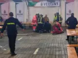 Personal sanitario atienden a la mujer a la que le cayó una viga encima en una carpa dedicada al Oktoberfest al comienzo de las Fiestas del pilar.