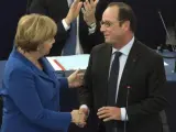 El presidente francés, François Hollande, saluda a la canciller alemana Angela Merkel, durante el pleno del Parlamento Europeo en Estrasburgo, Francia.
