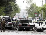Miembros de las Fuerzas de Seguridad afganas inspeccionan el lugar donde se ha producido un atentado suicida con bomba al paso de un convoy de la misión de la OTAN en Kabul (Afganistán).