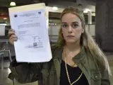 La mujer del líder opositor venezolano Leopoldo López, Lilian Tintori, con el documento que le impide salir de Venezuela para viajar a Europa.