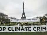 Manifestantes en París han pedido medidas drásticas para frenar el cambio climático mientras los líderes mundiales votaban sobre el acuerdo alcanzado en la Cumbre del Clima.