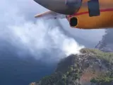 Los bomberos trabajan para extinguir el incendio en cala Estellencs.