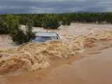Coche atrapado en un campo anegado en Alginet (Valencia), lluvias, inundaciones