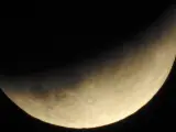 Dos semanas después del último eclipse total de Sol, la Luna en Sagitario pasó de derecha a izquierda a través de la sombra de la parte meridional de la Tierra, que cubrió hasta un 65% de su diámetro. En la imagen, el eclipse parcial visto desde Santiago de Compostela.