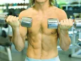 Imagen de un hombre haciendo pesas en un gimnasio.