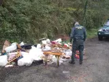 Un agente de la Guardia Civil junto al vertido de basura