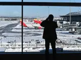 Vista de las pistas en la Terminal 4 del aeropuerto Adolfo Suárez Madrid-Barajas cubiertas parcialmente de nieve este lunes en Madrid.