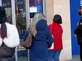 Personas mayores esperando para utilizar un cajero autom&aacute;tico de un banco en Barcelona.