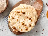 Homemade Roti Chapati Flatbread on gray concrete background top view. Freshly baked indian flatbrea