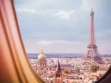 Paris and Eiffel tower panorama view from plane window illuminator during flight