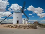 Beautiful snow-white windmills on blue sky background in Consuegra, province of Toledo, Spain.