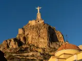 view of the statue of Christ of Monteagudo in Murcia in golden evening light undeer a blue sky
