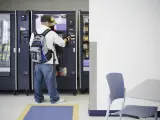 Persona comprando en una máquina expendedora.