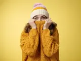 Charming playful charismatic girl hiding face pull sweater collar nose widen eyes surprised happy fool around having fun enjoying winter vacation mountains escape cold wearing warm clothes.