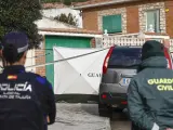 Agentes de la Guardia Civil y de la Policía Nacional en la vivienda donde se hallaron a los hermanos muertos.