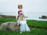 Anne Tyrrell Gogan reads a copy of Ulysses on Sandycove Point, Dublin, near to the James Joyce Martello Tower as she attends an event to celebrate the 100th anniversary of the publication of Joyce's flagship novel, Ulysses, and the 140th anniversary of the writers birth. Picture date: Wednesday February 2, 2022. (Photo by Brian Lawless/PA Images via Getty Images)