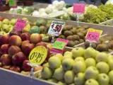 Manzanas y otras frutas en una frutería en un puesto de un mercado.