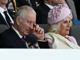 PORTSMOUTH, ENGLAND - JUNE 5: King Charles III and Queen Camilla react during the UK's national commemorative event for the 80th anniversary of D-Day, hosted by the Ministry of Defence on Southsea Common on June 5, 2024 in Portsmouth, England. King Charles III and Queen Camilla lead the commemorative events in Portsmouth ahead of the actual 80th Anniversary of D-Day on June 6th. Veterans, VIP Guests and school children are attending an event on Southsea Common. Portsmouth was where tens of thousands of troops set off to Normandy to participate in Operation Overlord. They established a foothold on the French coast and advanced to liberate northwest Europe. (Photo by Dylan Martinez - Pool/Getty Images)